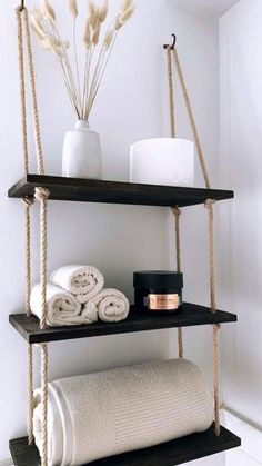 two shelves with towels and candles on them