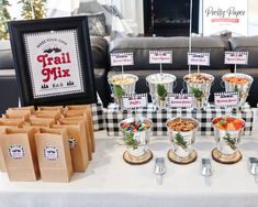 a table topped with lots of food next to a couch