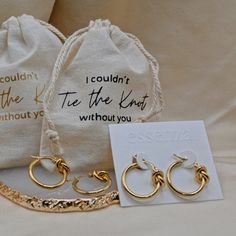 three pairs of gold hoop earrings and a card with the words i couldn't tie the knot without you