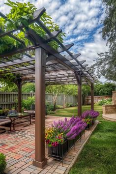 an outdoor patio with flowers and plants in the foreground under a blue cloudy sky