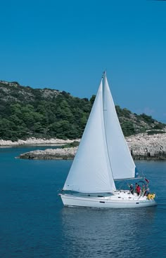 a sailboat with people on it in the water