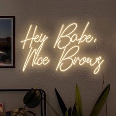 a neon sign that says hey bake, nice bros on the side of a wall