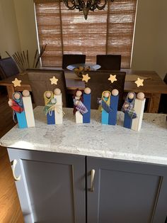 a kitchen counter topped with wooden dolls on top of it