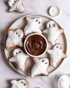 some cookies are on a plate with chocolate frosting in the shape of ghostes