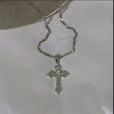 Discover the perfect blend of elegance and spirituality with our stunning Silver Cross Necklace. Crafted with intricate detailing, this necklace features a beautifully designed cross pendant adorned with sparkling stones that catch the light beautifully. The unique pattern of the chain adds a touch of sophistication, making it an ideal accessory for any occasion, from casual outings to formal events. This necklace not only serves as a fashion statement but also carries a deeper meaning, symbolizing faith and elegance. Whether you're purchasing it for yourself or as a meaningful gift for someone special, it's sure to be cherished. Features: Material: High-quality silver with a shimmering finish Pendant Size: [Insert size, e.g., 2.5 inches] Chain Length: [Insert length, e.g., 18 inches] Weig Silver Jewelry Streetwear, Silver Necklaces Cross, Cross Silver Necklace, Unique Cross Necklace, Cute Necklaces Silver, Silver Necklaces Stack, Silver Cross Necklace Aesthetic, Cute Cross Necklace, Cross Necklace Aesthetic