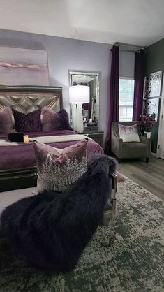 a large bedroom with purple and silver decor