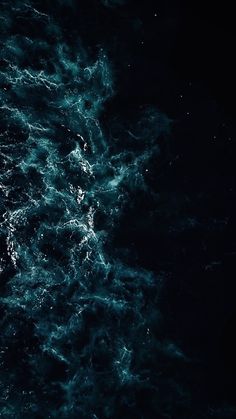 the water is very dark and blue in this photo, it looks like something from outer space