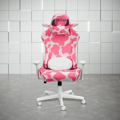 a pink and white computer chair with the word tech on it's head sitting in front of a tiled wall