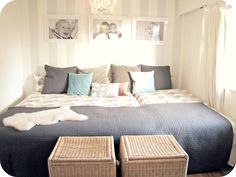 a large bed sitting in a bedroom next to two wicker baskets