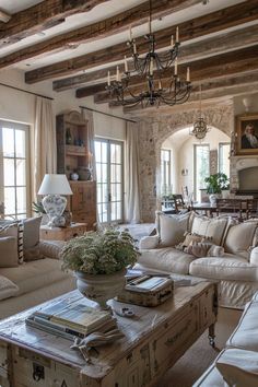 a living room filled with furniture and a chandelier