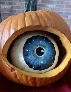 an eyeball in the center of a pumpkin