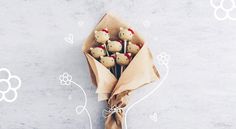 a bouquet of flowers wrapped in brown paper