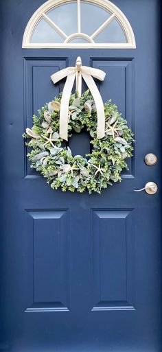 a blue door with a wreath on it