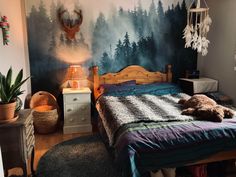 a bed room with a neatly made bed and a deer head on the wall