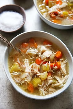 two bowls filled with chicken and vegetable soup