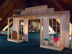 the inside of a building with wooden walls and windows on each side, in an attic