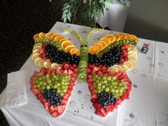 a butterfly made out of fruit sitting on top of a table