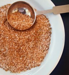 a white plate topped with brown sugar and a spoon