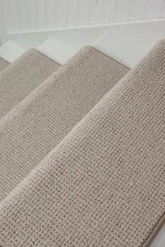 three beige rugs are lined up on top of each other in the same room