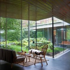 a room with glass walls and two chairs