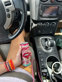 a woman is sitting in the driver's seat of a car with her feet on the steering wheel