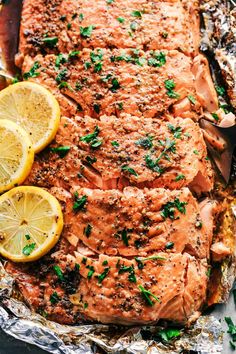 cooked salmon with lemons and parsley on foil