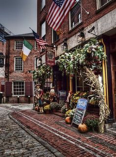 an old brick building with flags and decorations on the outside