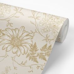 a beige and gold floral wallpaper with white flowers on the bottom half of it