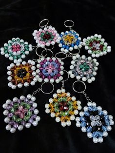 six key chains with different colors and designs on them, all made out of pearls