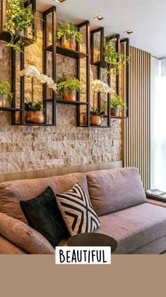 a living room filled with furniture and lots of potted plants on top of the wall