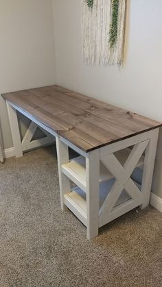 a wooden table sitting in the corner of a room