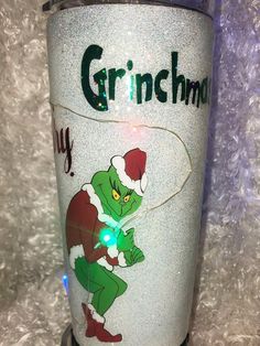 the grinch christmas light up tumbler is sitting on top of a white surface