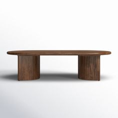 an oval wooden table sitting on top of a white floor