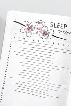 an open notebook with flowers on it and the words sleep tracker written in cursive writing