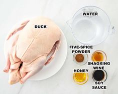 the ingredients to make a whole chicken on a white plate