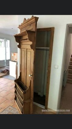 an old wooden armoire sitting in the middle of a room with tile flooring