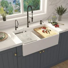 a white kitchen sink sitting under a window