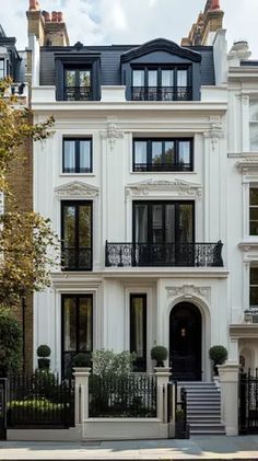 a large white house with many windows and balconies