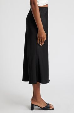 Sleek satin highlights your curves in this unforgettable midi skirt topped with the tiniest bow and dainty picot trim at the waist. 32 1/2" center front length (size Medium) Unlined 100% polyester Hand wash, line dry Imported Elegant Flared Skirt With Bias Cut, Elegant Bias Cut Midi Skirt, Sleek Midi Skirt Bottoms For Evening, Relaxed Bias Cut Skirt For Night Out, Night Out Bias Cut Relaxed Skirt, Classic Midi Length Evening Bottoms, Classic Midi-length Evening Bottoms, Evening Relaxed Fit Midi Skirt, Elegant Black Bias Cut Skirt