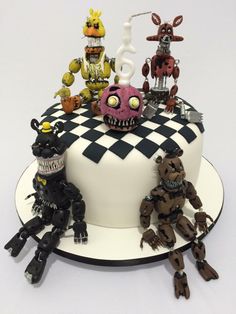 a cake that has some toys on top of it