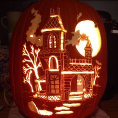 a carved pumpkin with an image of a castle on it