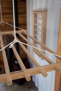 a wooden hammock hanging from a rope in a room