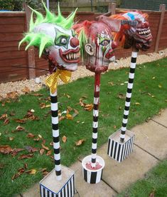 three painted fire hydrants in the shape of clown heads