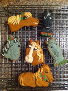 cookies decorated like horses on a cooling rack