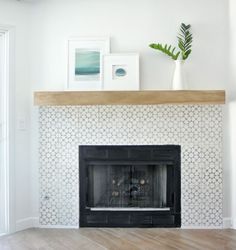 a living room with a fireplace and pictures on the mantle