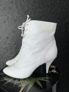 "Vintage Chandler's 1980's white leather lace up boots with 3.5\" heel, 6\" rise from leather sole. Re-soled with non-slip rubber sole & heel tap. Original leather laces intact. Clean insole. True to size 10 B (M, Medium standard width). Very sturdy, quality craftsmanship. Foot-bed measures 11\" long & approx 3.25\" wide. Light creasing, minor scuffs & very slight discoloration in leather. Hard to photograph but mentioning for transparency sake. These were either very cared for or rarely worn. A Fitted White Platform Ankle Boots, Fitted White Ankle Platform Boots, Vintage Heeled Boots With Leather Sole, Vintage High Heel Boots With Leather Sole, Vintage High Heeled Boots With Leather Sole, White High Heel Boots With Laces, White Lace-up Boots With Leather Sole, White Leather Lace-up Boots With Pointed Toe, White High Ankle Boots With Laces