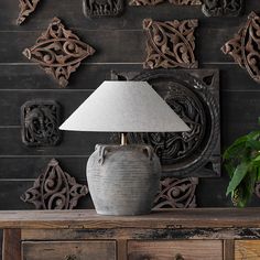 a table lamp sitting on top of a wooden dresser