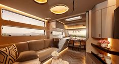 the interior of a motor home with wood flooring and modern lighting fixtures on the ceiling