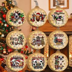 christmas ornaments hanging from the ceiling in front of a fireplace