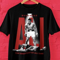 Muhammad Ali boxing graphic t shirt, Bella Canvas Ali boxing shirt, Muhammad Ali Greatest boxer of all time t shirt, Boxing fans shirt gift item.  Bella+Canvas 3001 * 100% Air Lume combed and ring spun cotton (fiber content may vary for different colors) * Light fabric (4.2 oz/yd² (142 g/m * Retail fit * Tear away label * Runs true to size With side seams Located along the sides, they help hold the garment's shape longer and give it structural support Shoulder tape Twill tape covers the shoulder Sporty Graphic Print T-shirt For Boxing, Crew Neck Graphic Print T-shirt For Boxing, Boxing Graphic, Ali Boxing, Muhammad Ali Boxing, Boxing Shirts, Boxing T Shirts, Fan Shirts, Muhammad Ali